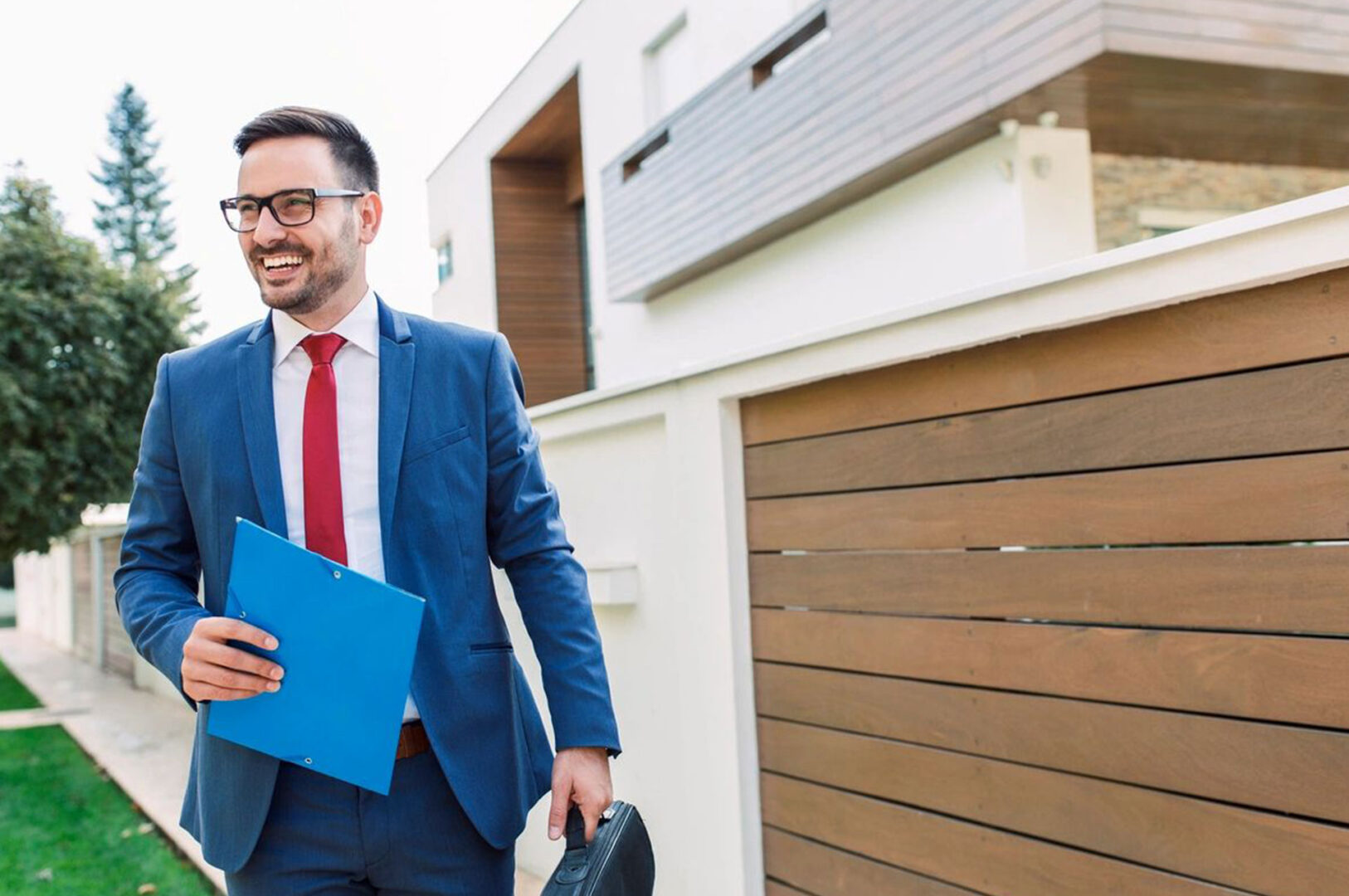 A man in a suit and tie holding papers